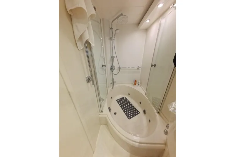  Yacht Photos Pics Luxurious bathroom with oval bathtub and shower in 2005 Princess 25M yacht.