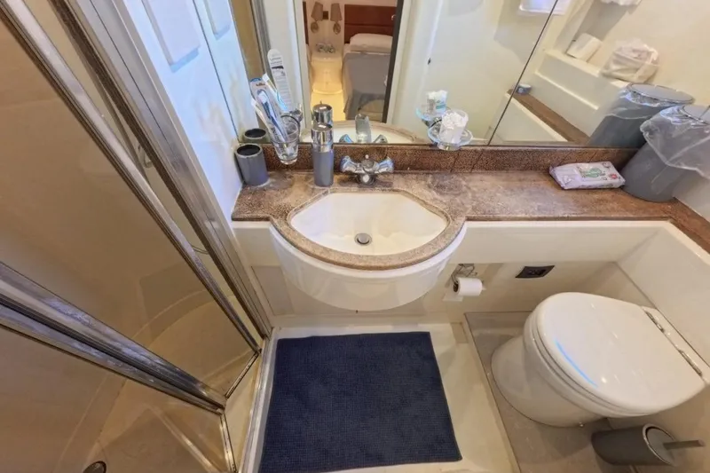  Yacht Photos Pics Compact bathroom in 2005 Princess 25M yacht with sink, toilet, and shower.