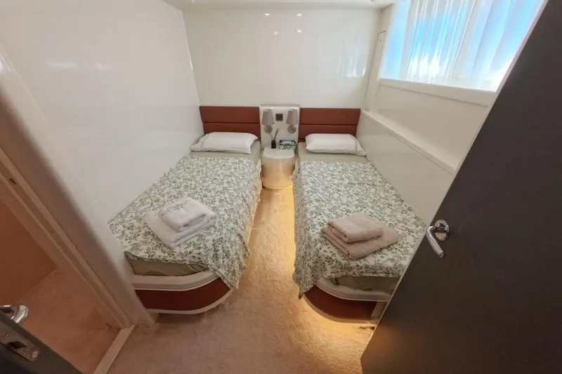  Yacht Photos Pics Twin cabin in 2005 Princess 25M yacht with floral bedding and soft lighting.