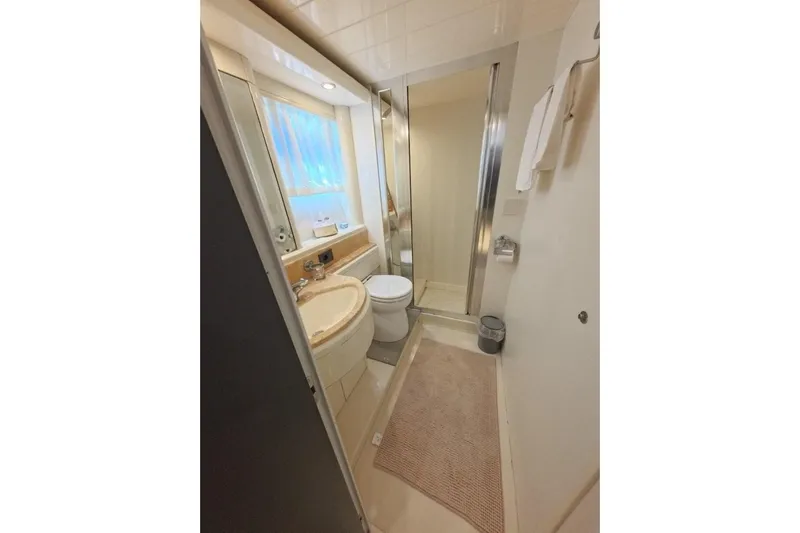  Yacht Photos Pics Bathroom interior of 2005 Princess 25M yacht, featuring shower, sink, and toilet.