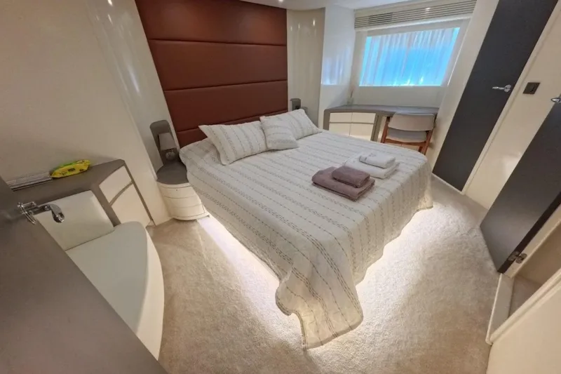  Yacht Photos Pics Luxurious bedroom interior in 2005 Princess 25M yacht, featuring elegant decor and comfortable bedding.