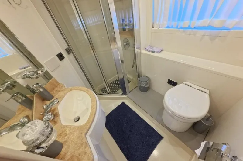  Yacht Photos Pics Luxurious bathroom in 2005 Princess 25M yacht with shower, sink, and toilet.