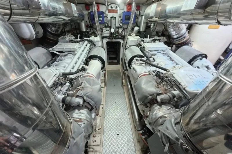  Yacht Photos Pics Engine room of a 2005 Princess 25M yacht, featuring dual engines and metallic components.