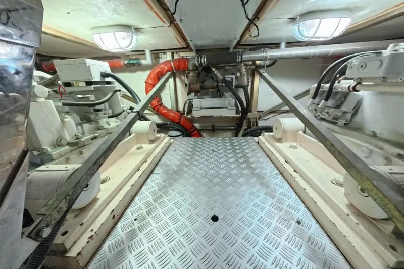  Yacht Photos Pics Engine room of a 2005 Princess 25M yacht, featuring mechanical components and piping.