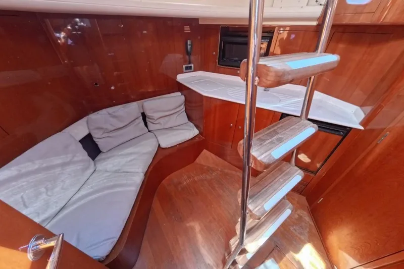  Yacht Photos Pics Interior of 2005 Princess 25M yacht with wooden finish and cozy seating area.