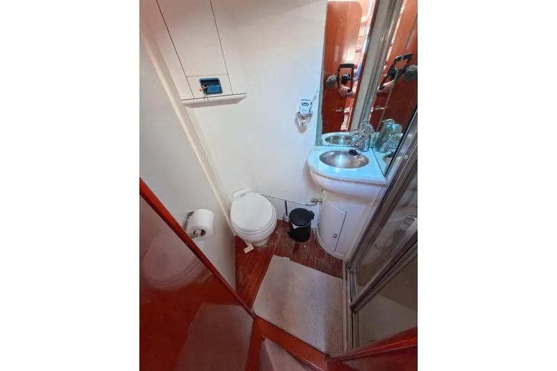  Yacht Photos Pics Compact bathroom in a 2005 Princess 25M yacht, featuring a toilet, sink, and shower.
