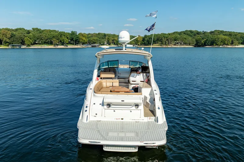  Yacht Photos Pics 2017 Sea Ray Sundancer 350 yacht on a serene lake with lush green shoreline.