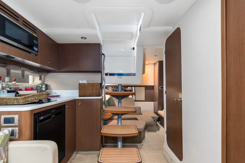  Yacht Photos Pics Interior of 2017 Sea Ray Sundancer 350 yacht, featuring modern kitchen and cozy seating area.