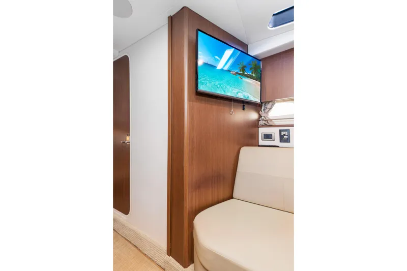  Yacht Photos Pics 2017 Sea Ray Sundancer 350 interior with TV, beige seating, and wooden paneling.