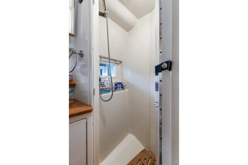  Yacht Photos Pics Shower area in 2017 Sea Ray Sundancer 350 yacht with modern fixtures and wooden accents.