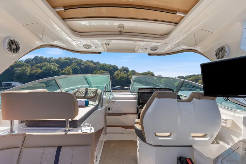  Yacht Photos Pics 2017 Sea Ray Sundancer 350 cockpit with luxurious seating and modern navigation equipment.