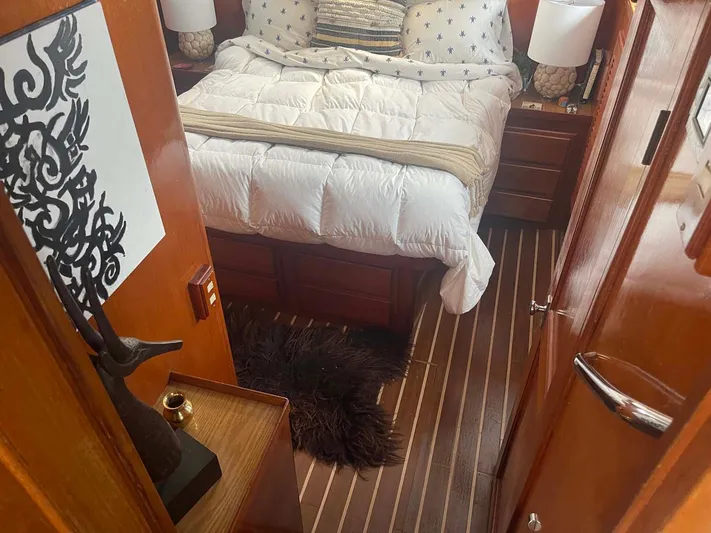 Sea Bird Yacht Photos Pics Cozy bedroom interior of 1985 DeFever 40 Offshore Cruiser with wood accents and plush bedding.