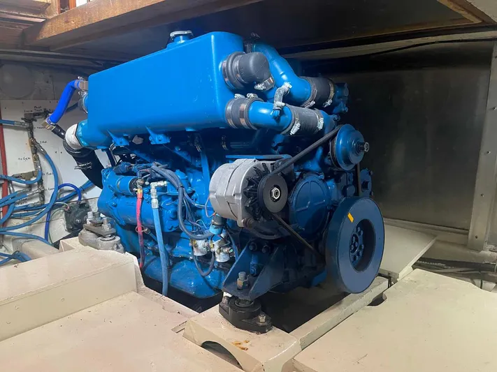 Sea Bird Yacht Photos Pics Engine of 1985 DeFever 40 Offshore Cruiser, painted blue, in a boat's engine room.