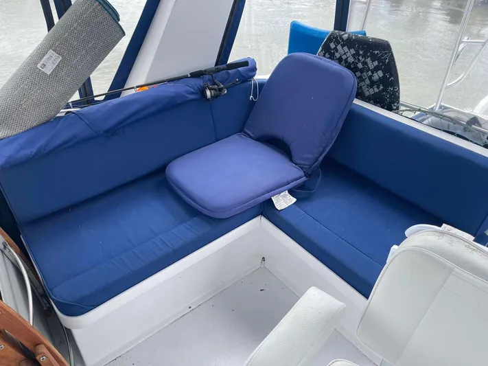 Sea Bird Yacht Photos Pics 1985 DeFever 40 Offshore Cruiser interior with blue cushioned seating.
