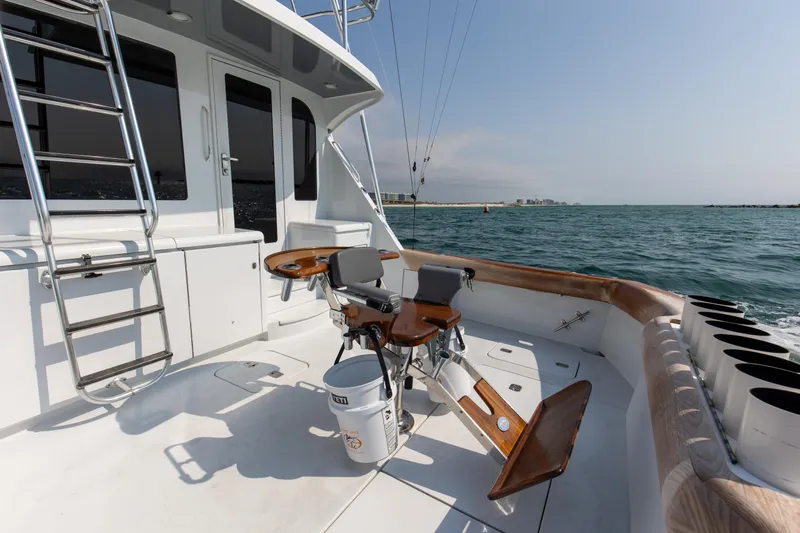  Yacht Photos Pics Hatteras 60 Convertible 2003 yacht with fishing chair on deck.