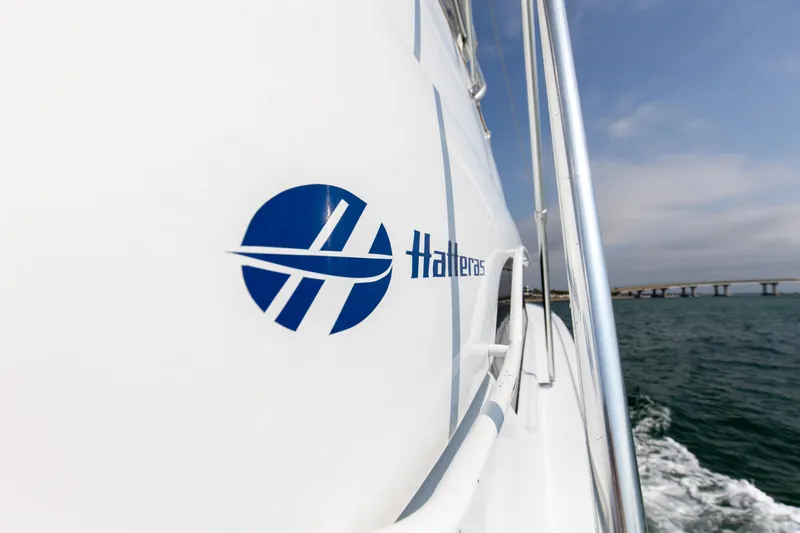  Yacht Photos Pics Hatteras 60 Convertible 2003 on water with bridge in background.