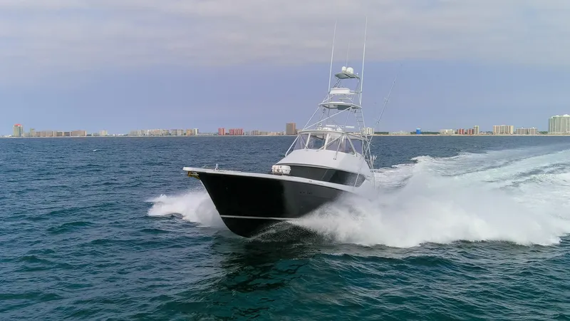  Yacht Photos Pics 2003 Hatteras 60 Convertible yacht cruising on open sea.