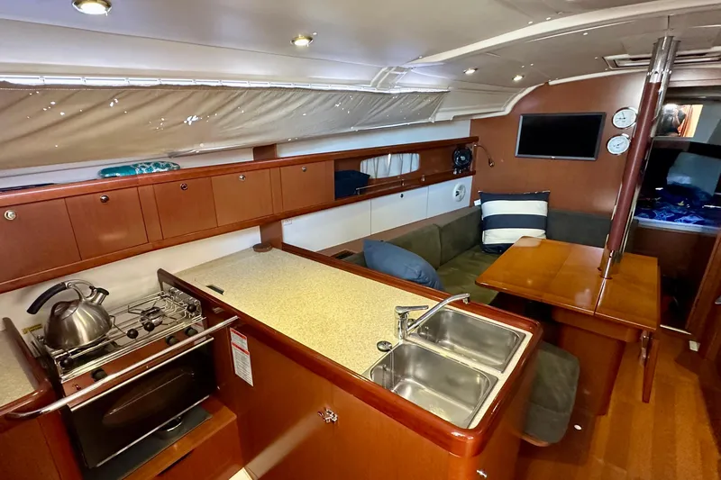  Yacht Photos Pics Interior of 2013 Beneteau Oceanis 37 yacht with kitchen and seating area.