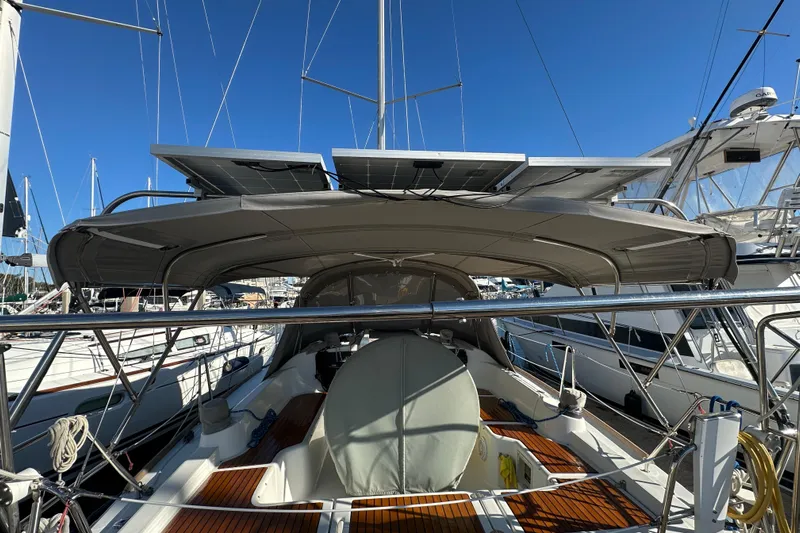  Yacht Photos Pics 2013 Beneteau Oceanis 37 sailboat with solar panels, docked in a marina.