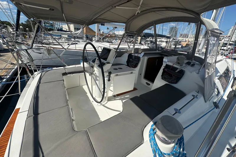  Yacht Photos Pics 2013 Beneteau Oceanis 37 sailboat cockpit with steering wheel and seating, docked at marina.