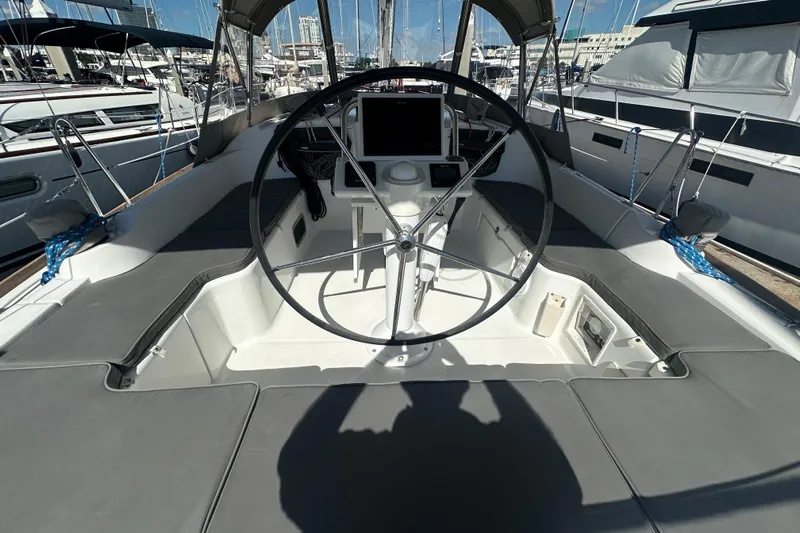  Yacht Photos Pics Cockpit of 2013 Beneteau Oceanis 37 sailboat with steering wheel and navigation equipment.