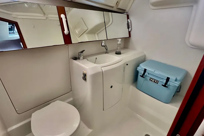  Yacht Photos Pics Bathroom of 2013 Beneteau Oceanis 37 yacht with sink, mirror, and Yeti cooler.