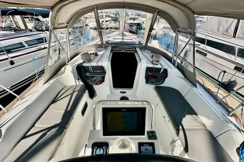  Yacht Photos Pics Cockpit view of 2013 Beneteau Oceanis 37 sailboat, featuring navigation equipment and seating.