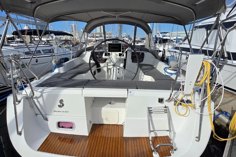  Yacht Photos Pics 2013 Beneteau Oceanis 37 sailboat cockpit with steering wheel, docked at marina.