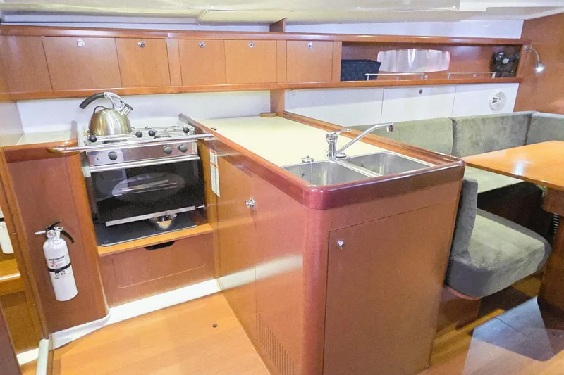  Yacht Photos Pics Interior of 2013 Beneteau Oceanis 37 yacht with kitchen and seating area.