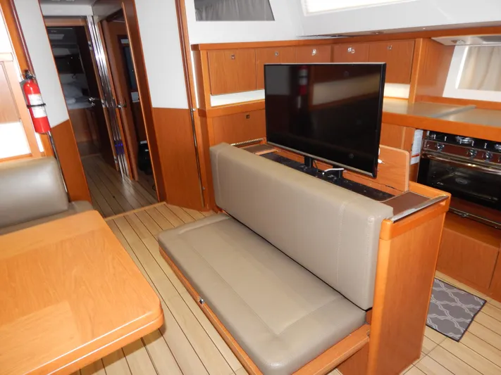  Yacht Photos Pics Interior of 2015 Beneteau Sense 55 yacht with TV and seating area.