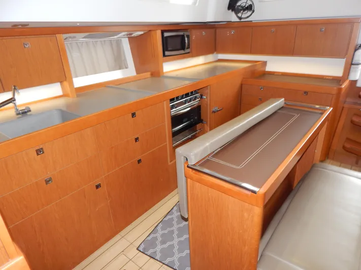  Yacht Photos Pics Interior of 2015 Beneteau Sense 55 yacht, featuring modern kitchen and dining area.