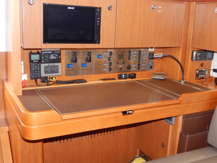  Yacht Photos Pics Navigation station on 2015 Beneteau Sense 55 yacht with control panels and electronics.