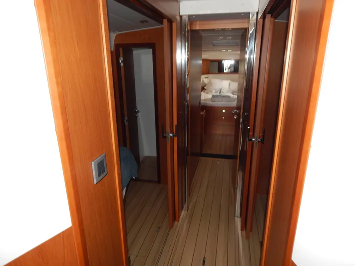  Yacht Photos Pics Interior hallway of 2015 Beneteau Sense 55 yacht with wooden finish.