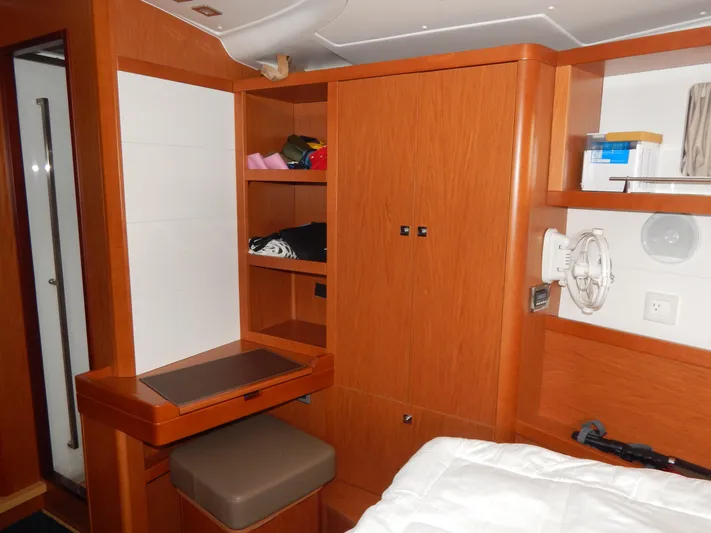  Yacht Photos Pics Interior of 2015 Beneteau Sense 55 yacht with wooden cabinetry and seating.