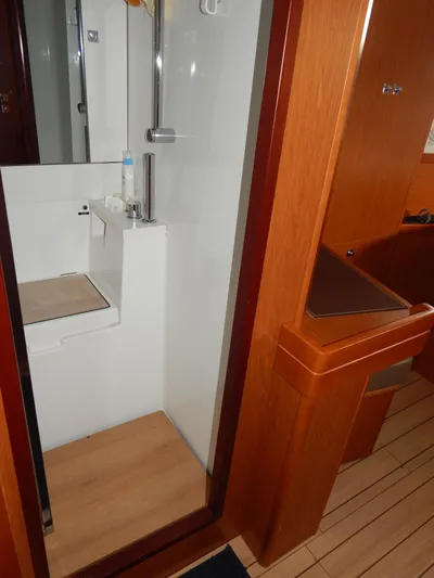  Yacht Photos Pics 2015 Beneteau Sense 55 yacht bathroom with modern shower and wooden accents.