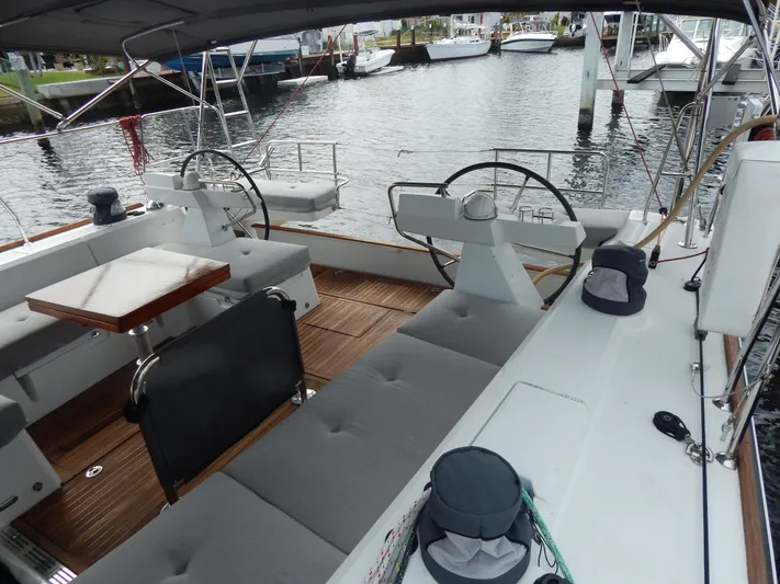  Yacht Photos Pics 2015 Beneteau Sense 55 yacht interior with dual steering wheels and seating area.