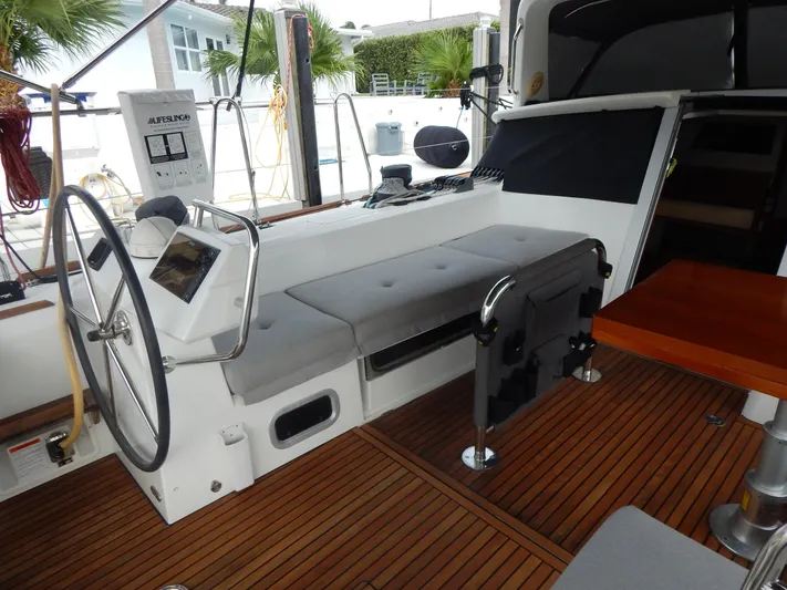  Yacht Photos Pics 2015 Beneteau Sense 55 yacht cockpit with steering wheel and seating area.