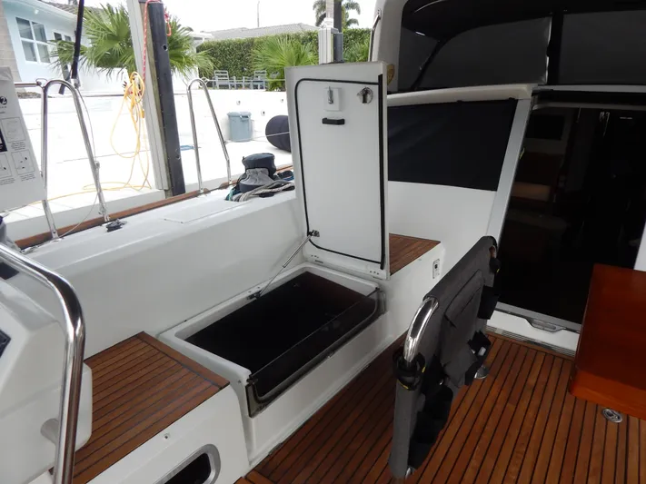  Yacht Photos Pics 2015 Beneteau Sense 55 yacht cockpit with open storage compartments and teak flooring.