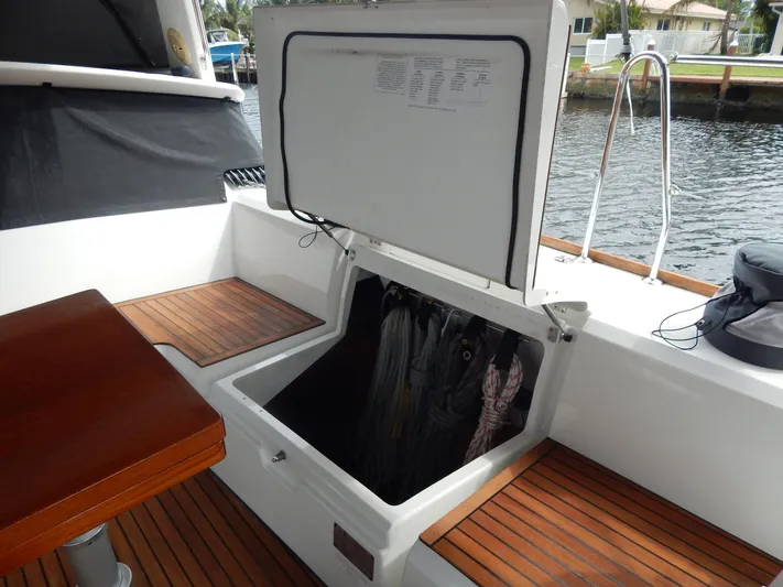  Yacht Photos Pics Beneteau Sense 55 yacht storage compartment, 2015 model, with wooden deck and seating area.