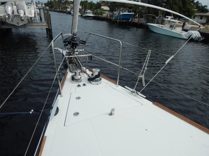  Yacht Photos Pics 2015 Beneteau Sense 55 sailboat deck view, docked in a marina.