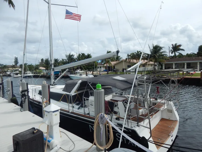  Yacht Photos Pics 2015 Beneteau Sense 55 yacht docked, American flag, tropical setting.