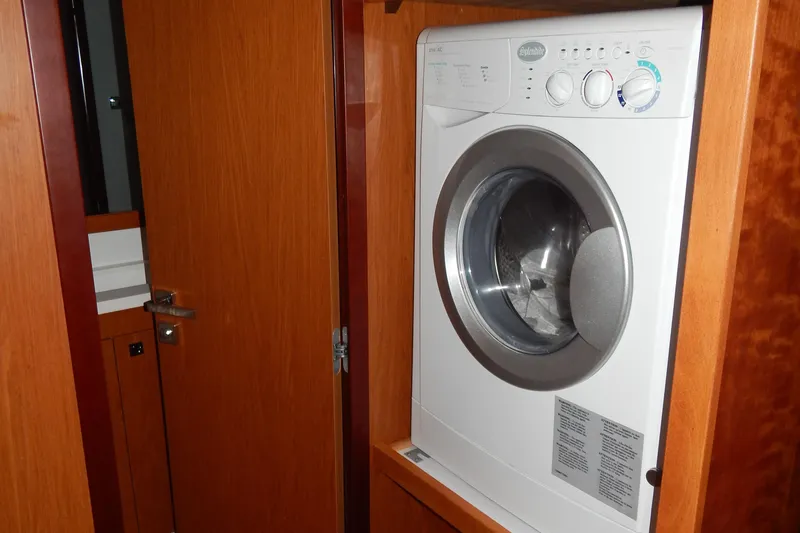  Yacht Photos Pics Washing machine inside 2015 Beneteau Sense 55 yacht's wooden interior.