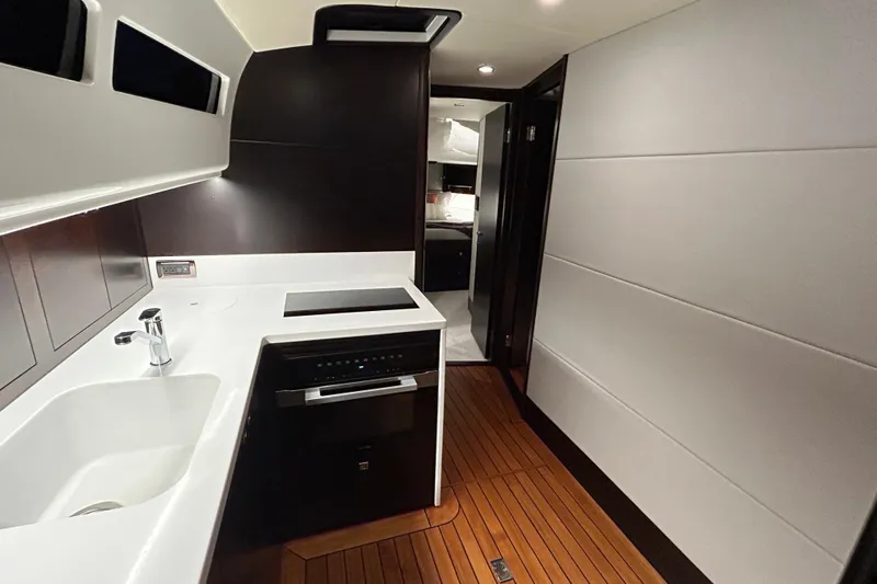Gt60 Yacht Photos Pics 2021 Palm Beach Motor Yachts GT60 interior kitchen with modern design and wood flooring.