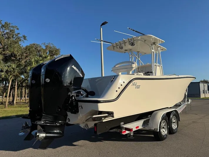  Yacht Photos Pics 2023 SeaVee 290B boat on trailer with dual Mercury engines, parked outdoors.