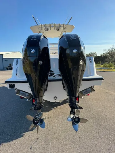  Yacht Photos Pics 2023 SeaVee 290B boat with dual outboard engines, parked outdoors.