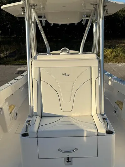  Yacht Photos Pics 2023 SeaVee 290B boat interior with cushioned seating and storage compartment.
