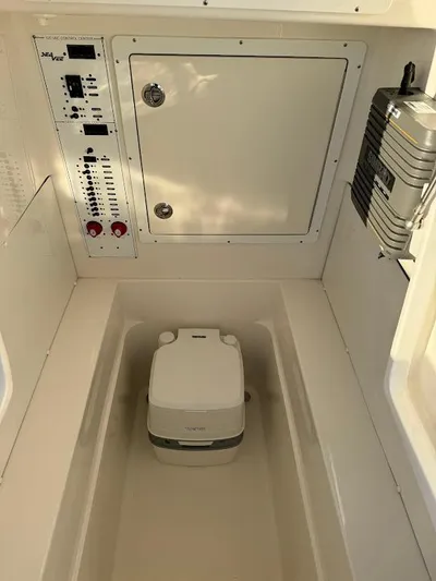  Yacht Photos Pics 2023 SeaVee 290B boat interior with control panel and portable toilet.