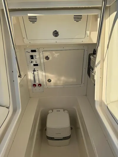  Yacht Photos Pics 2023 SeaVee 290B boat interior with control panel and portable toilet.