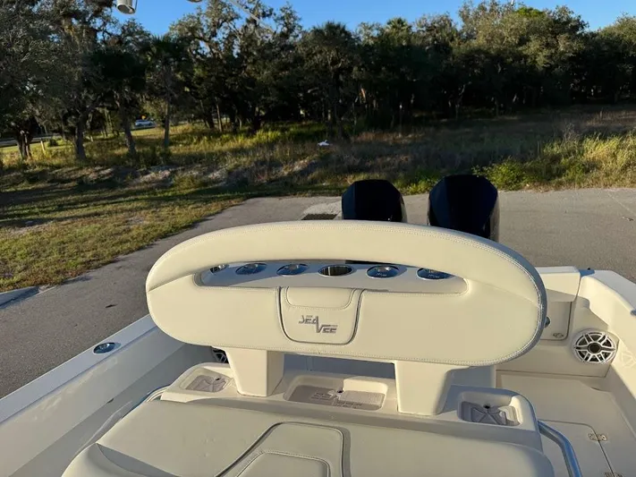  Yacht Photos Pics 2023 SeaVee 290B boat interior with helm, outdoors in a natural setting.