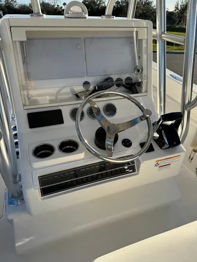  Yacht Photos Pics 2023 SeaVee 290B boat console with steering wheel and controls.